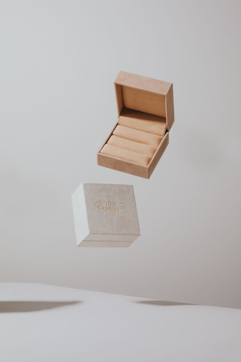 Creative product photography of jewelry boxes, one blush and one white. 100 Ways Jewelry velvet jewelry boxes. Commercial product photography by Cat and Jeff Chang of The Apartment Creative